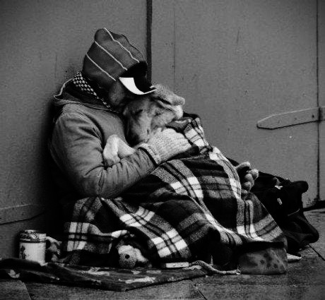 homeless hugging dog